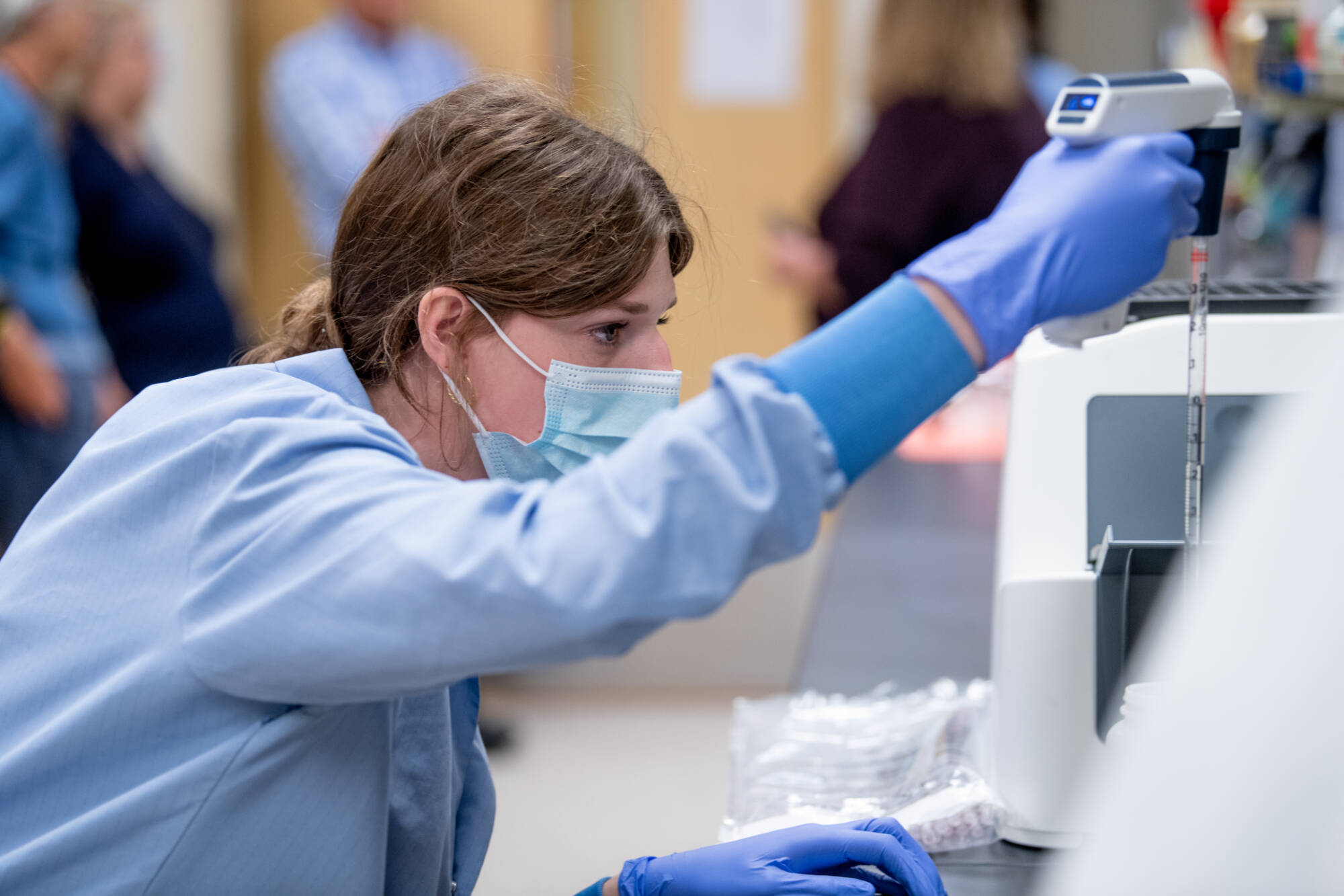 Student using serological pipette.